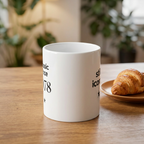 White ceramic coffee mug with 'still iconic' text and star graphic