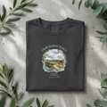 Dark heather gray t-shirt with round neck and scenic landscape graphic on chest