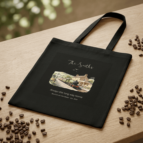 Black cotton tote bag with scenic house graphic and text “Always the long way home”