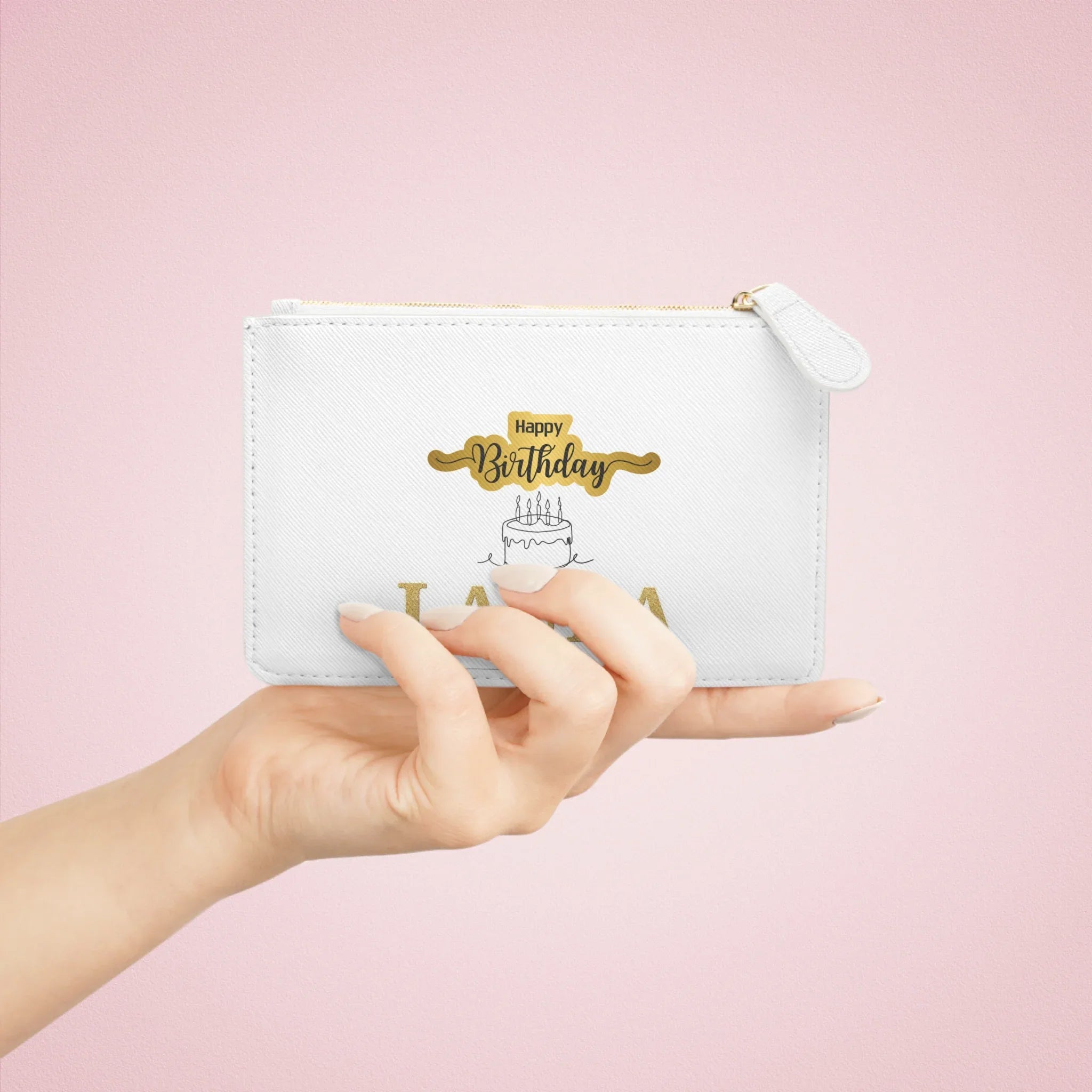 White mini clutch bag with gold zipper, Happy Birthday cake print, held in hand