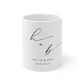 White ceramic mug with monogram h + b and date 28.07.2023, printed on front.