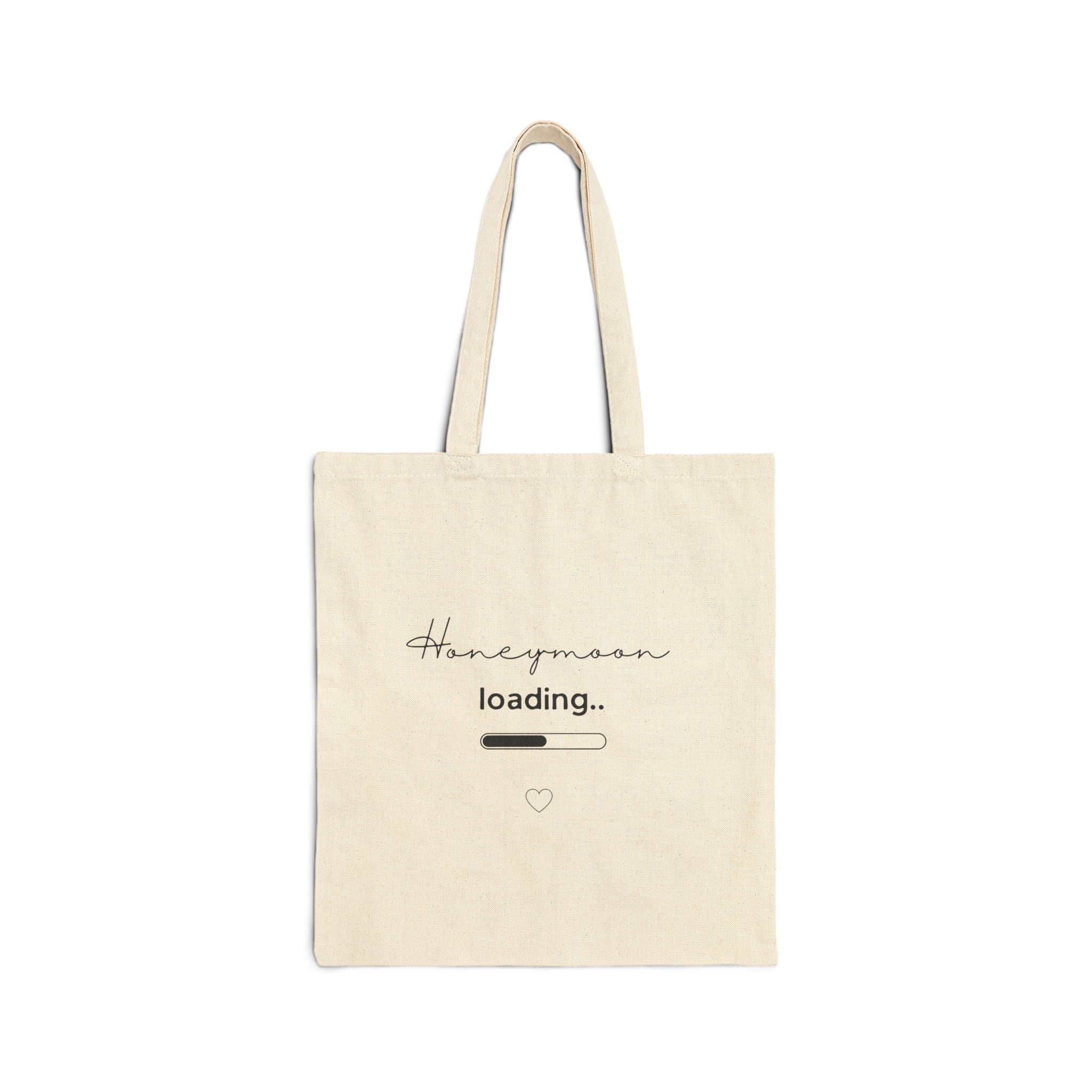 Natural canvas tote bag with "Honeymoon loading..." text and heart icon