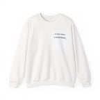 Off-white crewneck sweatshirt with a year wiser, a world kinder print