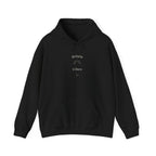 Black hoodie with “delulu vibes” graphic at chest, pullover style, front pocket.
