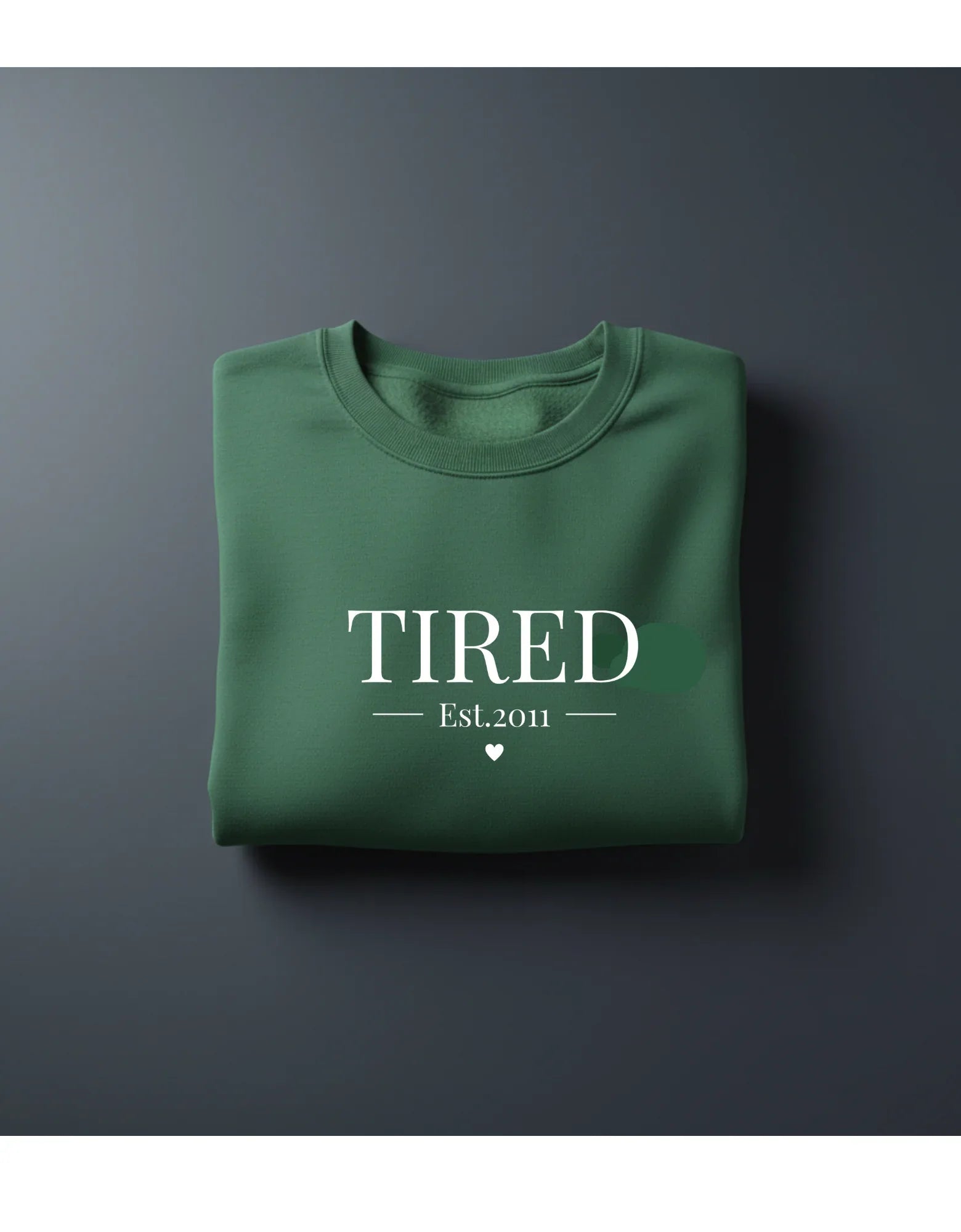 Green crewneck sweatshirt with 'TIRED' and 'Est.2011' text print