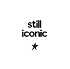 Ceramic coffee mug with “still iconic” text and a star graphic on white
