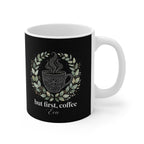 Black ceramic coffee mug with white handle, coffee-cup graphic surrounded by leaves