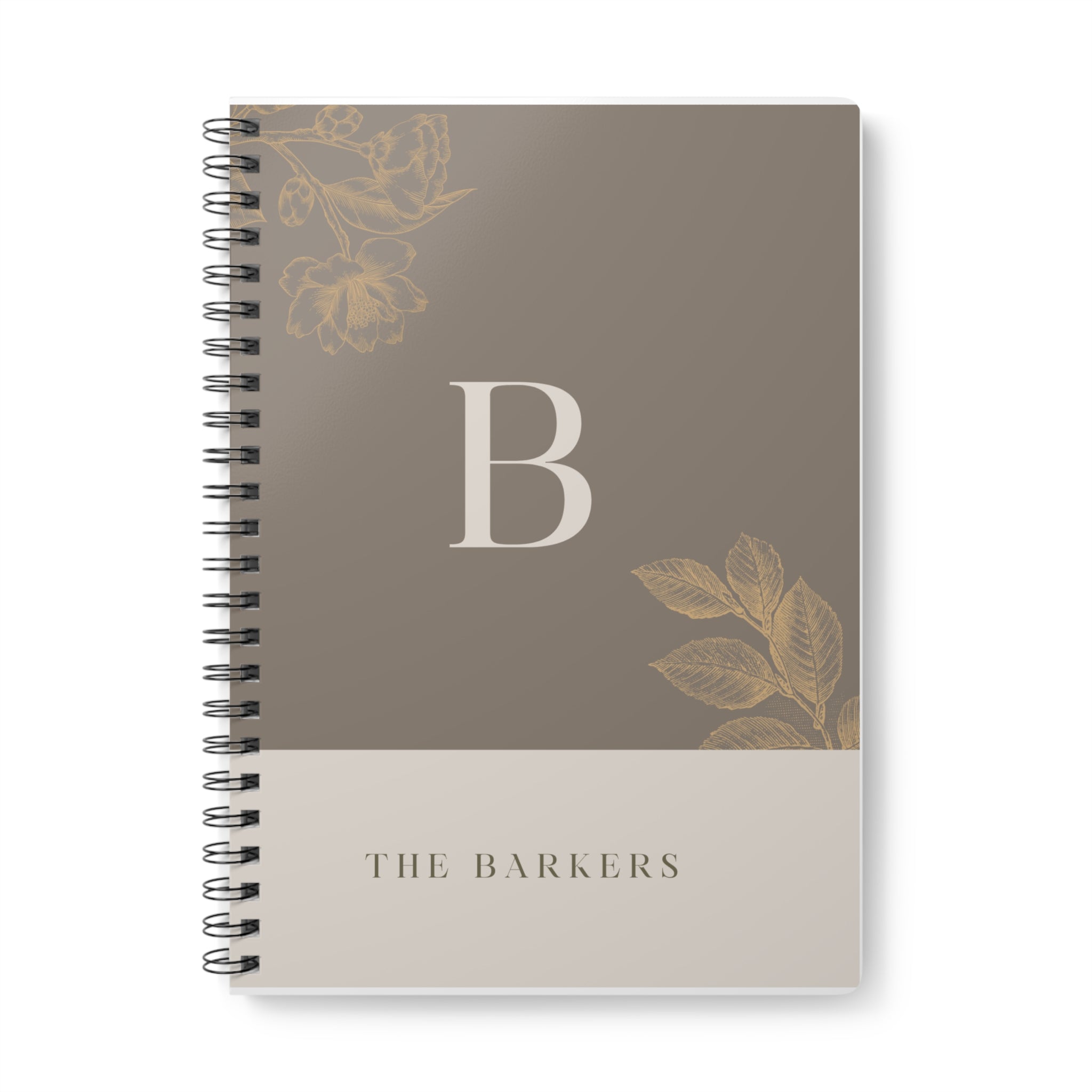 A5 notebook with taupe cover, gold monogram B, and floral corner accents; spiral binding.