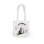 White coffee tote with white handles, “STAY GROUNDED” coffee mug graphic on front