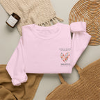 Light pink sweatshirt with floral heart location graphic and printed text on chest