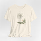 Natural off-white hiking T-shirt with woods scene graphic and quote text on front