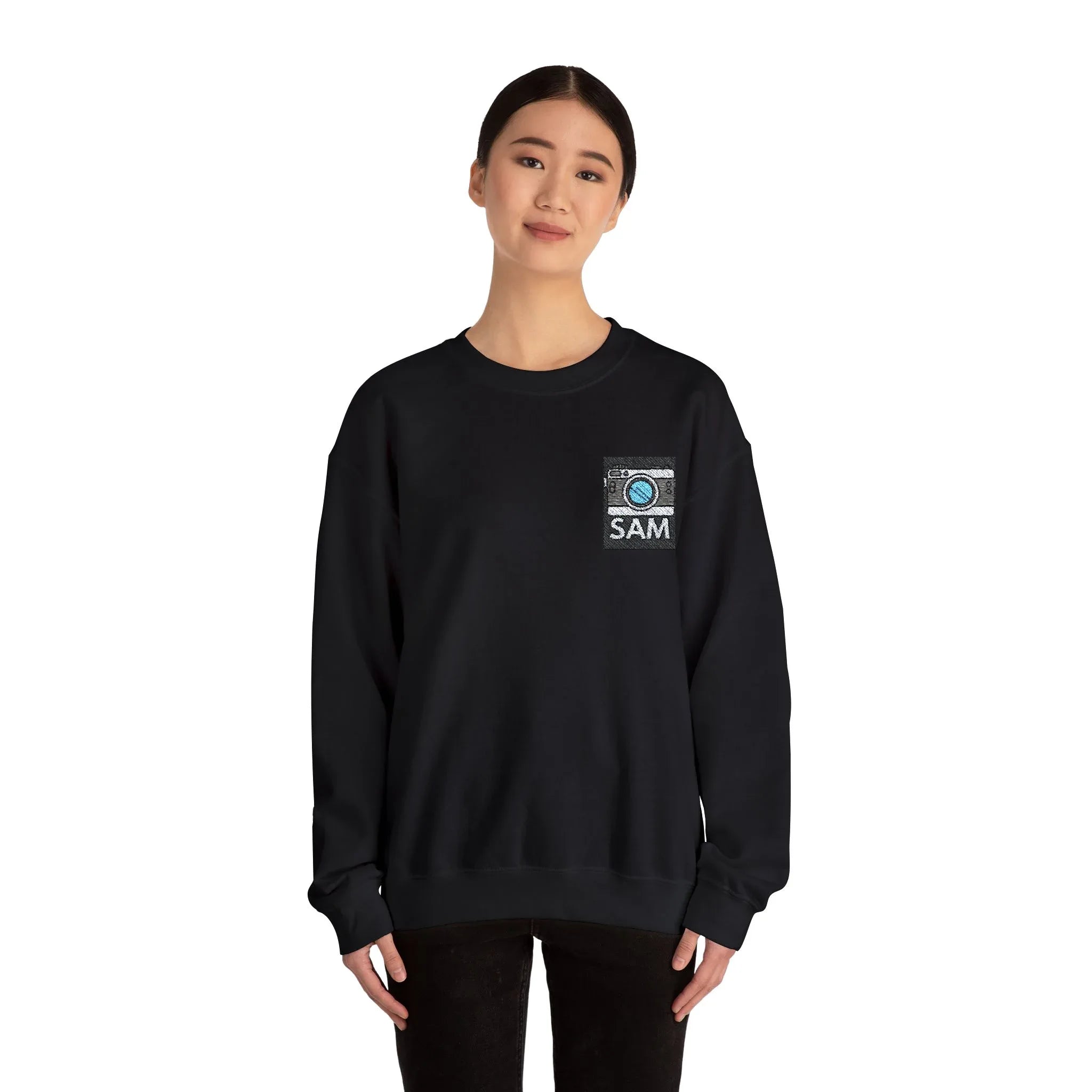 Black crewneck sweatshirt with embroidered camera icon and name SAM on chest