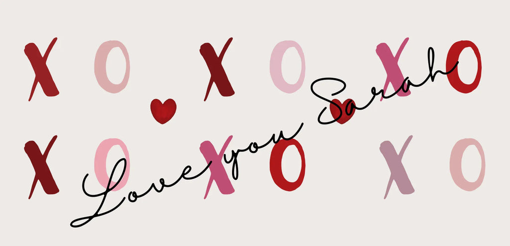 Close view of white mug design with red XO hearts and name “Sarah”