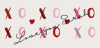 Close view of white mug design with red XO hearts and name “Sarah”
