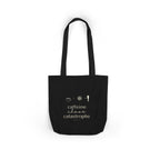 Black tote bag with “caffeine chaos catastrophe” text and small icon graphics.