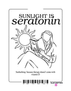 Front view of white canvas tote bag with black “Sunlight is serotonin” graphic