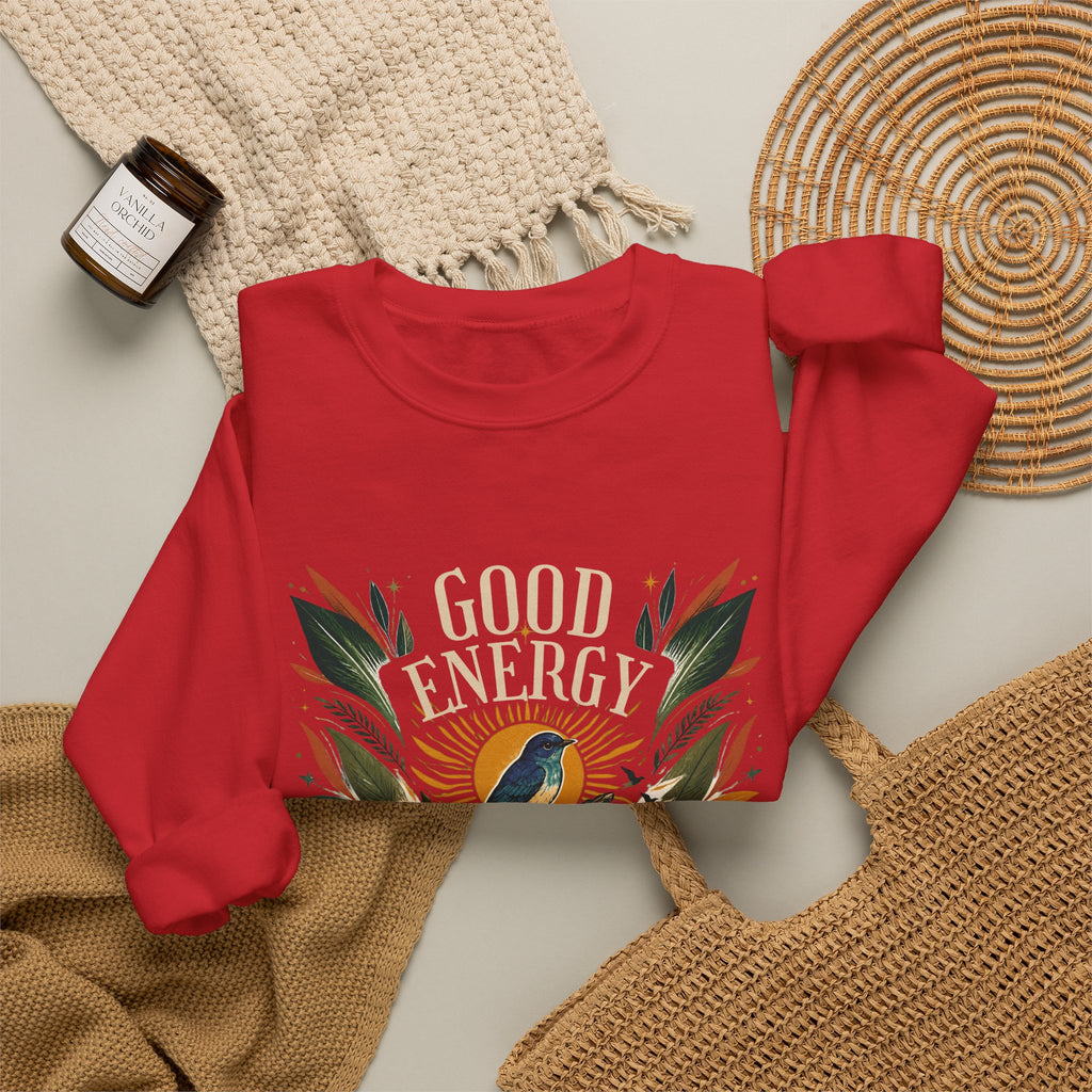 Red unisex sweatshirt with botanical “Good Energy” front graphic