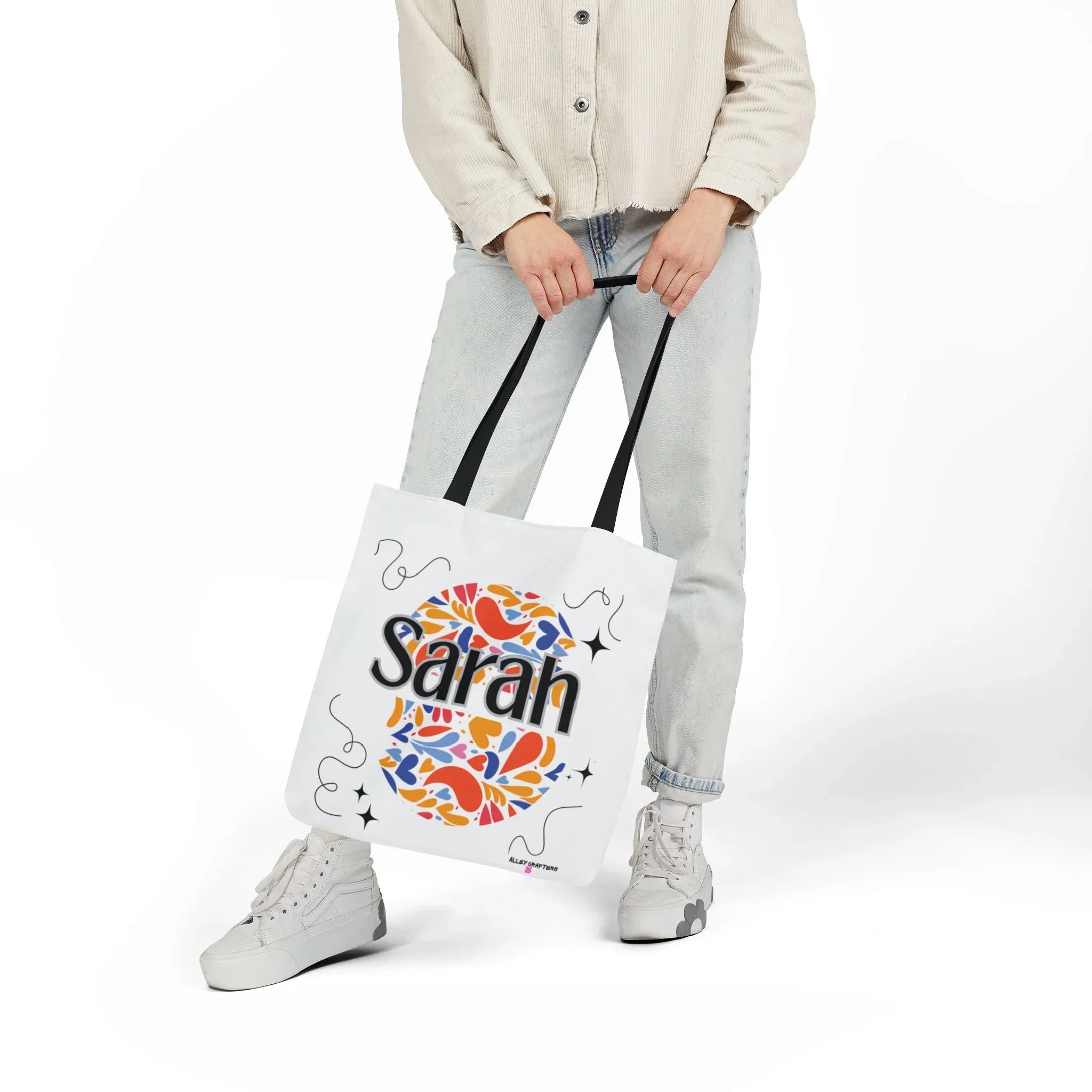 Personalized floral tote bag, white with black handles and “Sarah” heart design.
