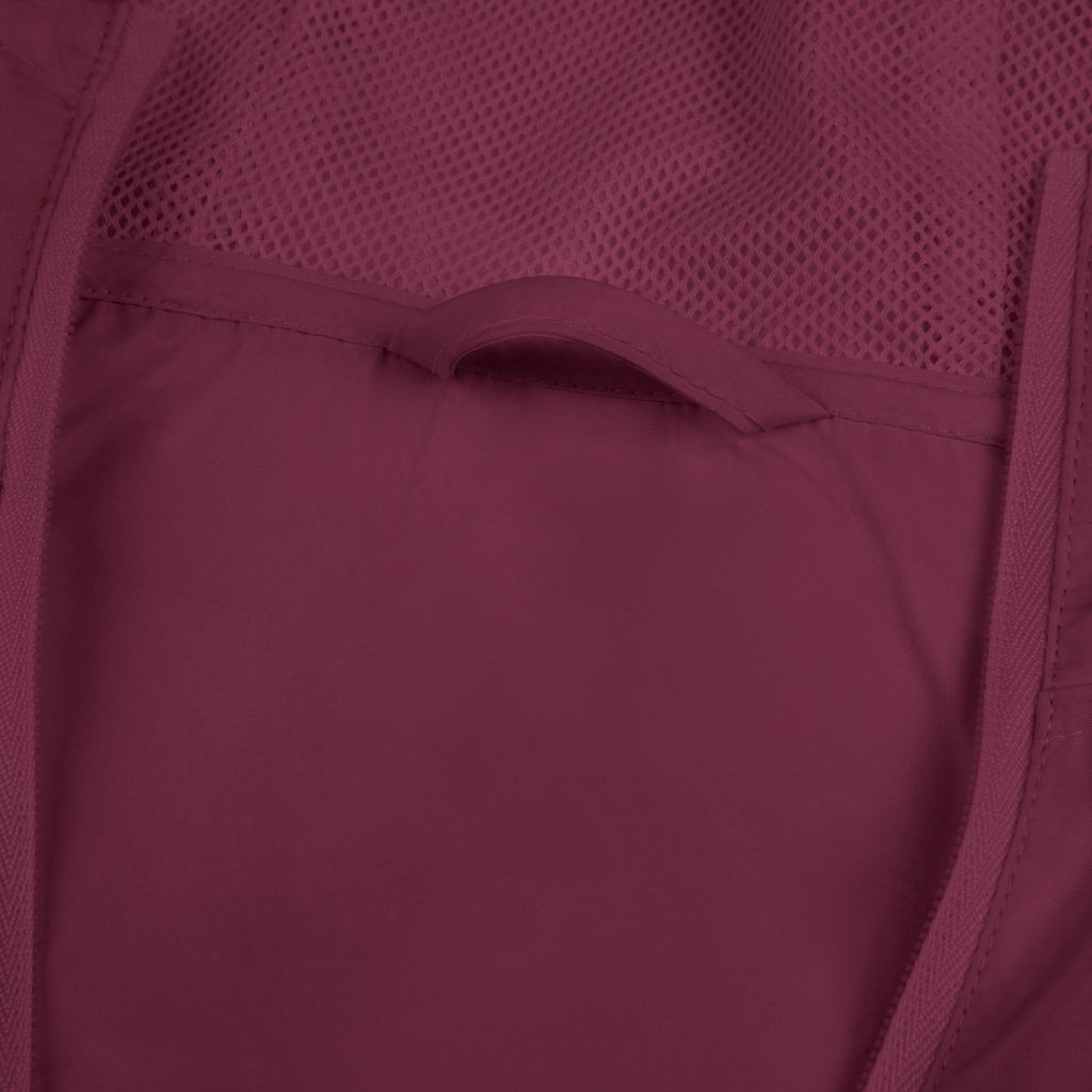 Maroon windbreaker jacket lining and pocket seam close-up