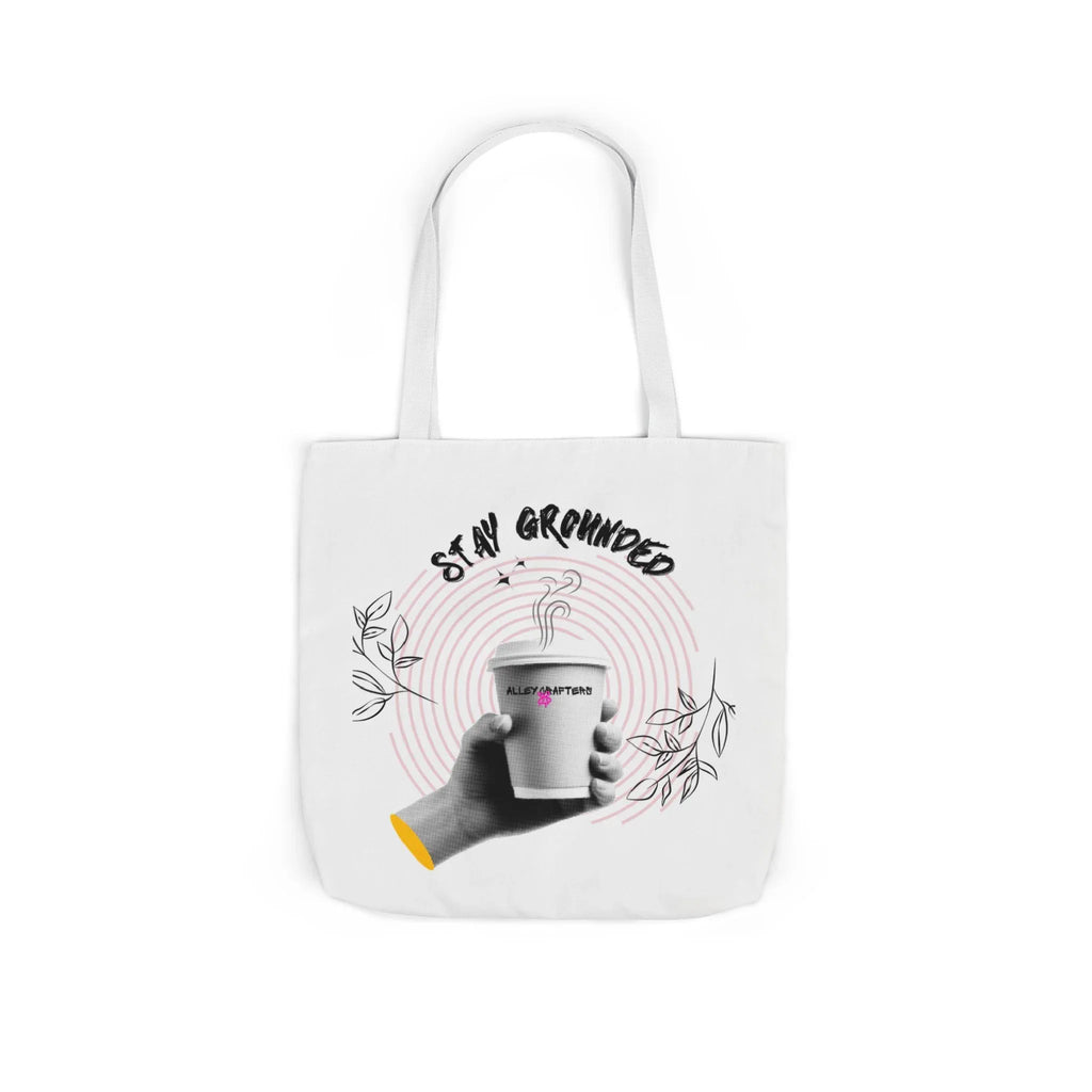 White coffee tote with white handles, centered “STAY GROUNDED” coffee mug print