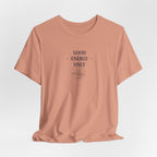 Peach T-shirt with crew neck and 'Good Energy Only' sun graphic on chest