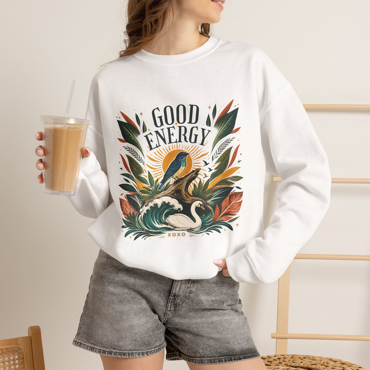 White unisex sweatshirt with “GOOD ENERGY” botanical bird graphic on front