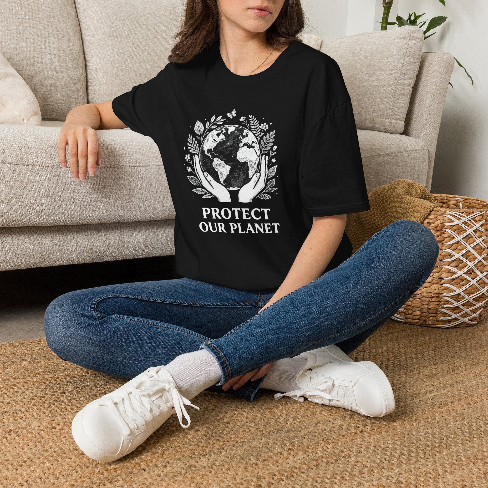 Black T-shirt on model with white globe-and-leaf “Protect Our Planet” front print