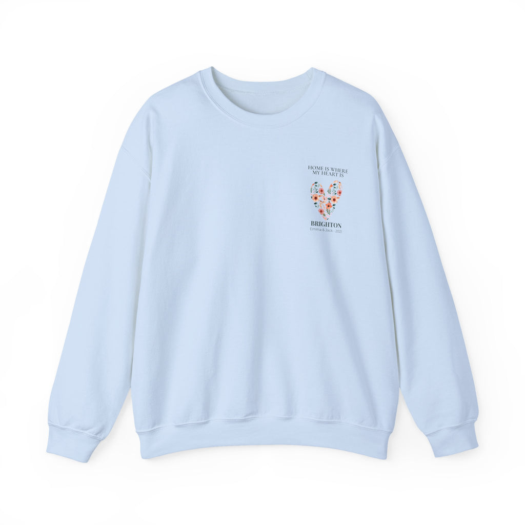 Light blue personalised sweatshirt with floral heart graphic and location text on chest