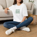 White T-shirt on a seated person, chest print reads 'WIFE MUM BOSS'