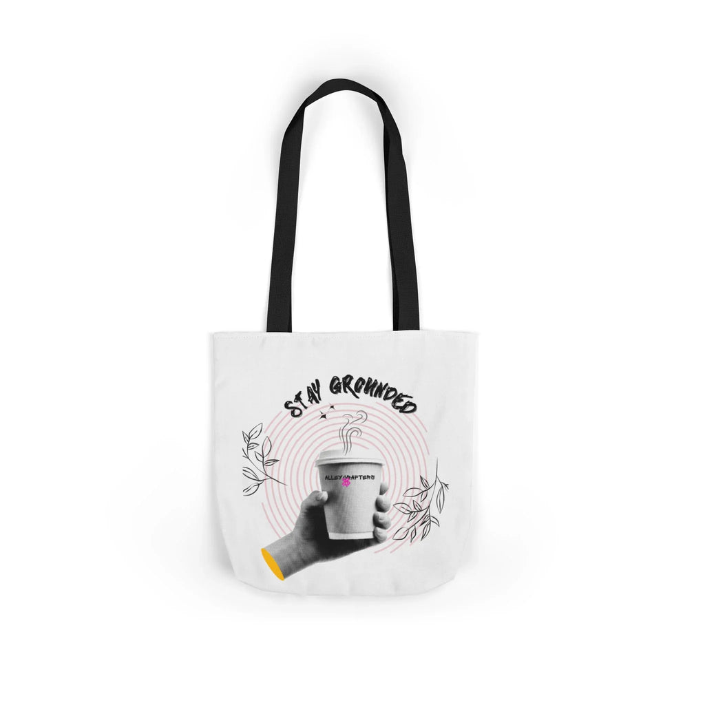 White coffee tote with black handles, “STAY GROUNDED” graphic and coffee mug on front