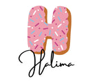 Pink sprinkle donut letter graphic with “Natasha” script text in black.