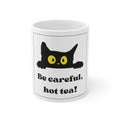White ceramic mug with black cat and yellow eyes, 'Be careful, hot tea!' text