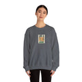 Charcoal gray crewneck sweatshirt with front graphic print, worn by a woman