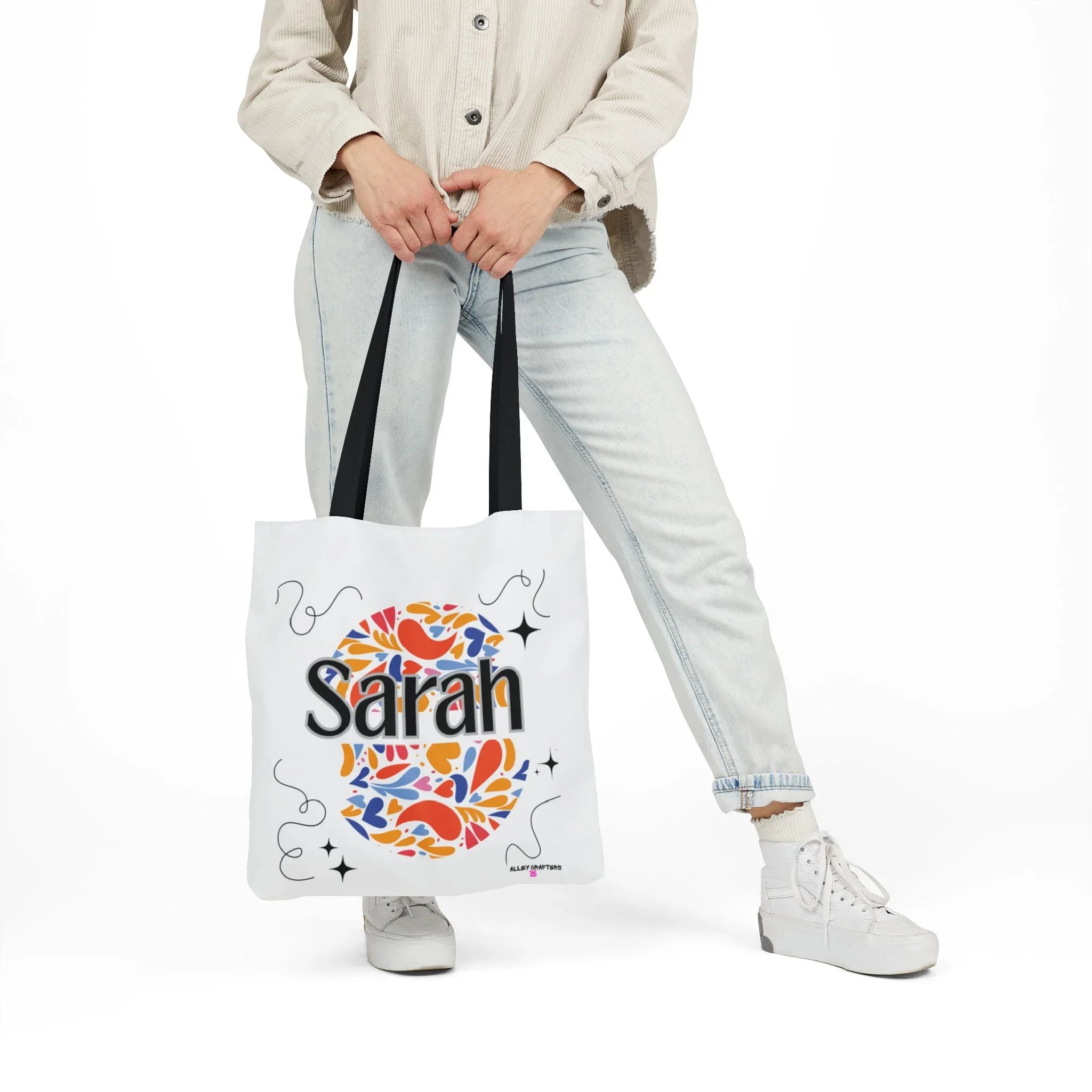 Personalized floral tote bag, white with black handles and “Sarah” heart motif.