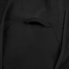Black windbreaker jacket close-up: vented mesh panel and curved pocket seam detail.
