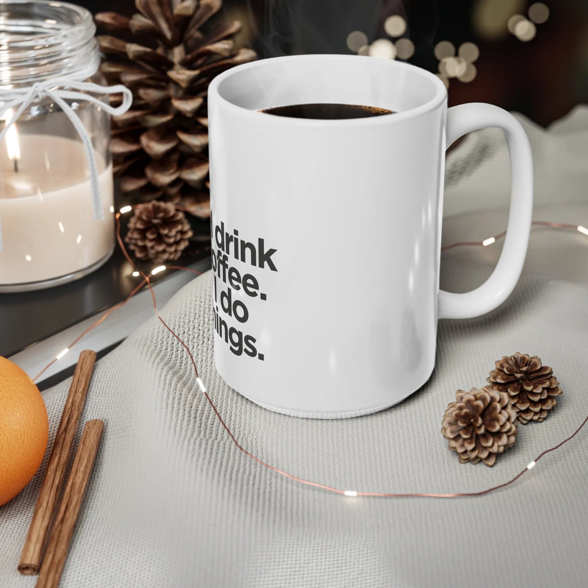 White ceramic coffee mug on a table with black quote text and visible handle.