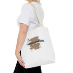 White canvas tote bag with light tan handles and brown splash “Haveagreatday.”