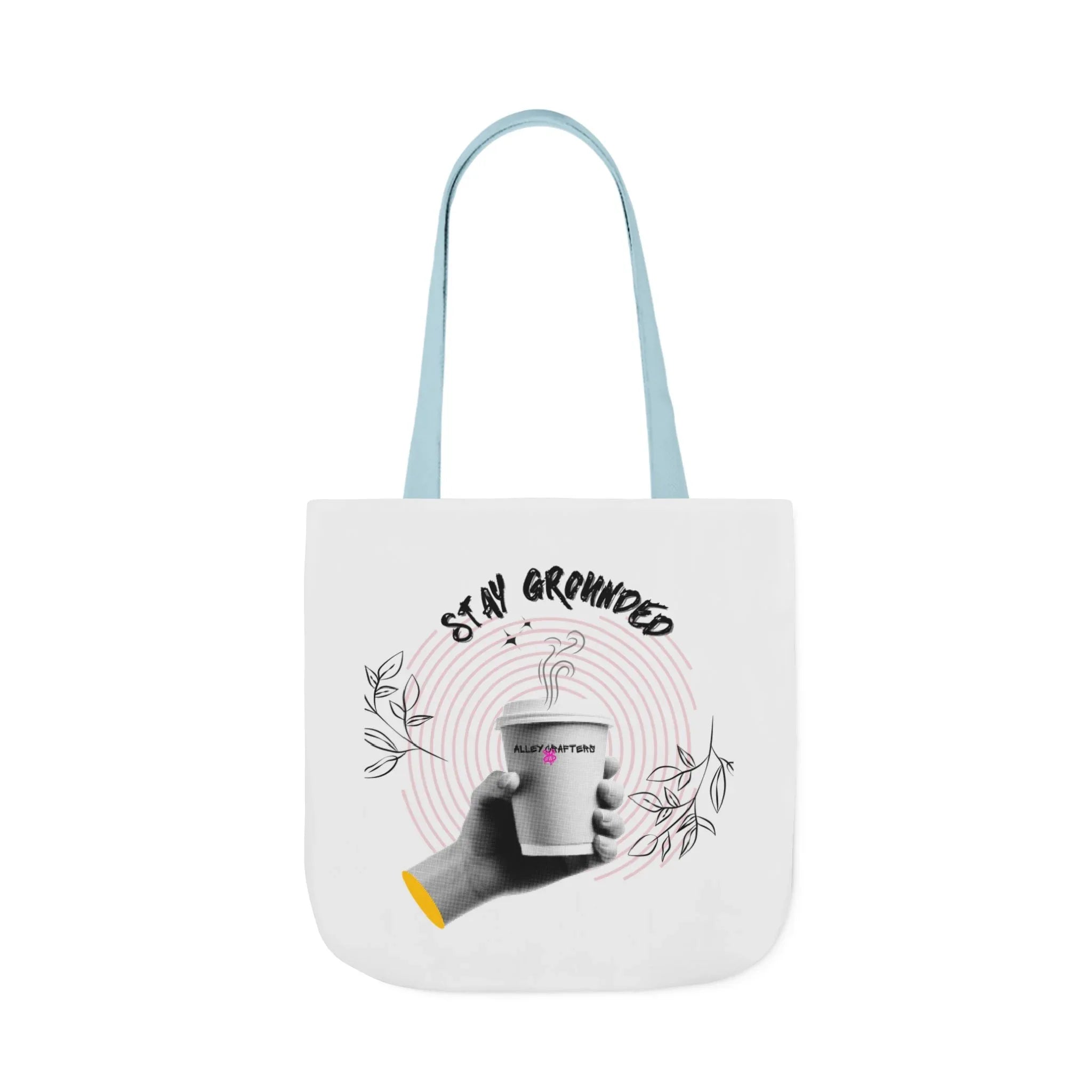White coffee tote with light blue handles, “STAY GROUNDED” coffee mug design on front