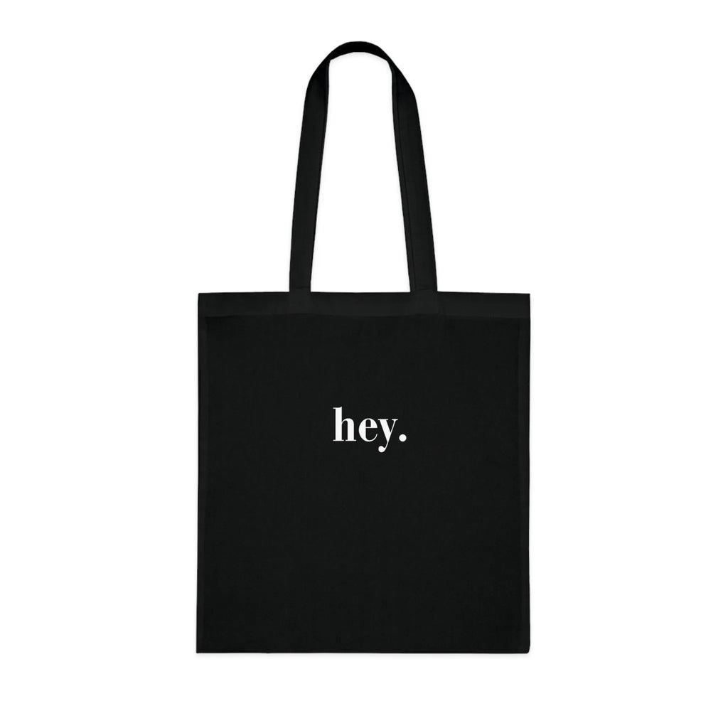 Black cotton tote bag with custom text "hey."