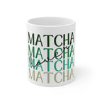 White ceramic matcha mug with green MATCHA lettering, close-up view