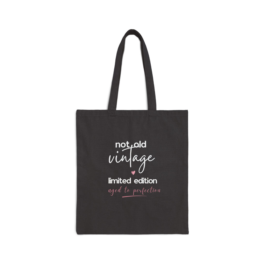 Black canvas tote bag with 'not old vintage' and 'limited edition' front text