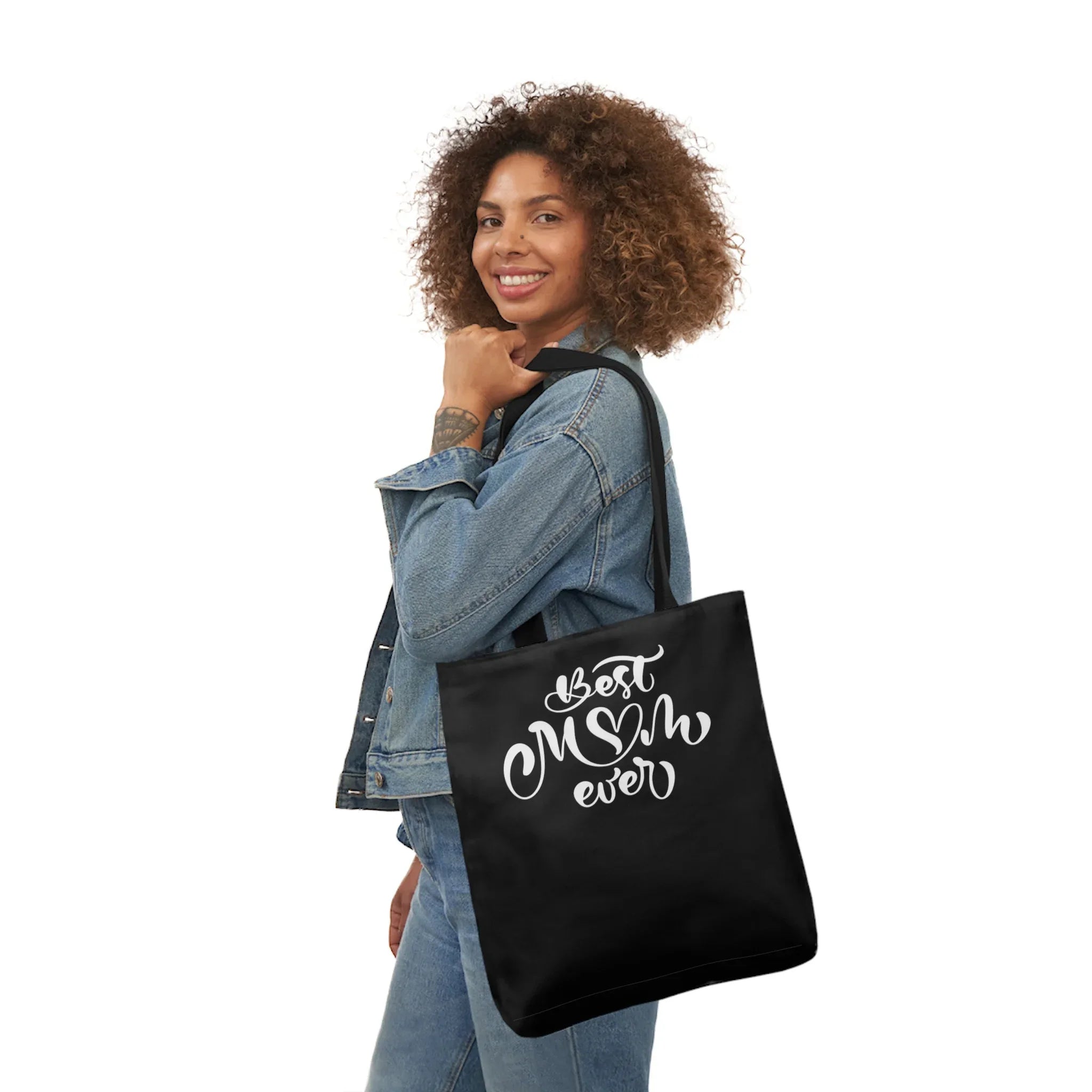 Black canvas tote bag with “Best Mum ever” white print, worn over shoulder