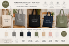 Set of personalized cotton tote bags in grey, black, navy, white, and green with printed quotes.