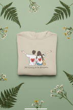 White hoodie with couple heart graphic and 'Still Waiting for the Honeymoon' text on chest.
