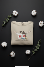Beige pullover hoodie with drawstring hood and couple graphic on chest