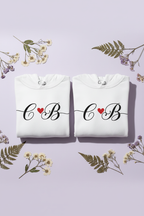 Couples initials hoodie set in white, front monograms with red heart and drawstring hood