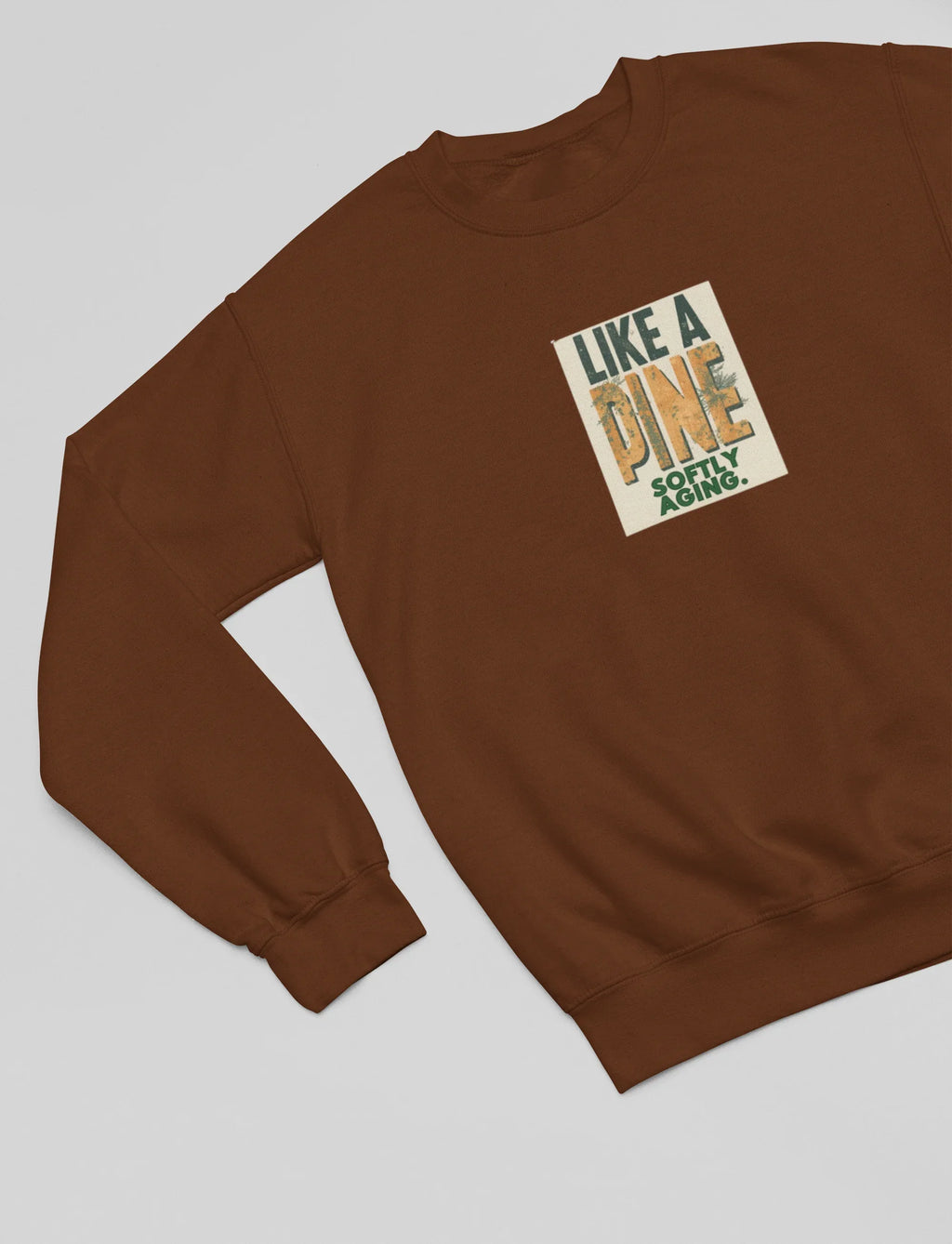 Brown sweatshirt close-up with square front graphic print