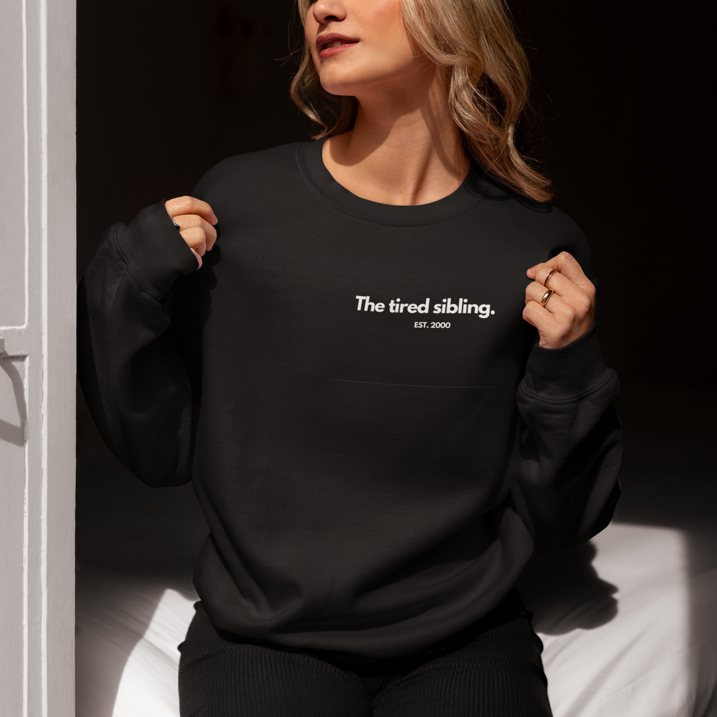 Personalised sibling sweatshirt with “The thoughtful sibling” text and EST year on black sweatshirt