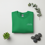 Green crewneck sweatshirt with a year wiser, a world kinder print