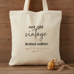 Natural canvas tote bag with 'not old vintage' and 'limited edition' print on front